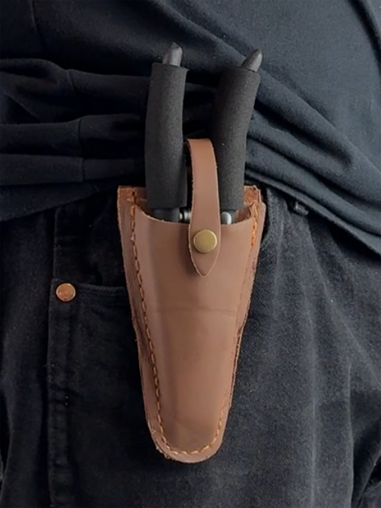 Close-up of the durable leather surface and fine stitching of the pruner sheath. The sheath offers rust protection, ensuring your gardening tools stay secure and ready for use.