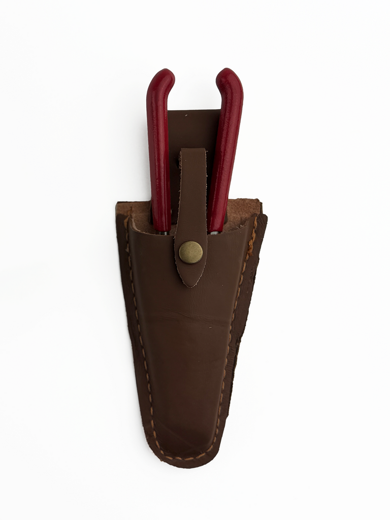 Close-up of the durable leather surface and fine stitching of the pruner sheath. The sheath offers rust protection, ensuring your gardening tools stay secure and ready for use.